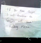 Photo of hand-written sign saying 'If you are caught I will remove the grafitti with your fucking face'.
